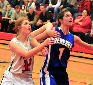 Josie Peery battles for rebounding position against a taller Genesee player.