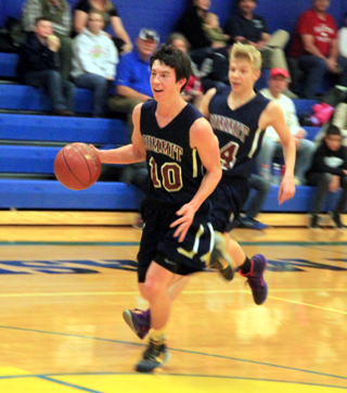 Summits Tyler Krogh heads for a transition lay-up as Caleb Currier follows during Summits blowout win at Nezperce.