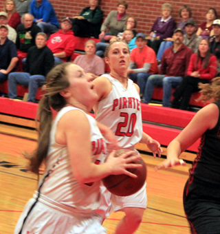 Angela Wemhoff goes for a layup against Moscow as Hailey Danly watches.