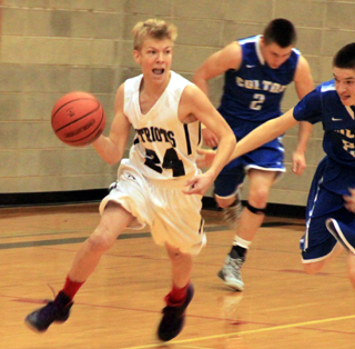 Caleb Currier drives down the floor after a steal against Colton.