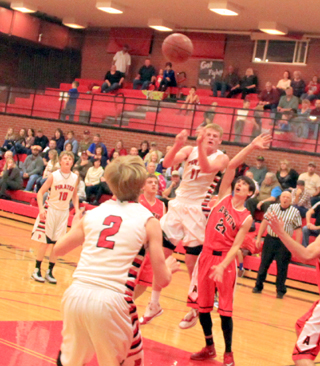 Jake Bruner passes the ball to Tyson Schlader in the Asotin game. At left is Brandon Higgins.