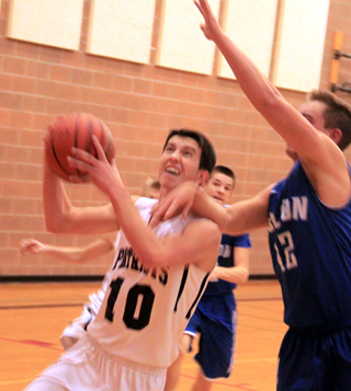 Tyler Krogh gets fouled as he goes for a lay-up against Colton.