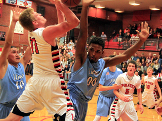 Jake Bruner was fouled as he went for a basket on this play. Also shown are Hunter Chaffee and Brandon Higgins.