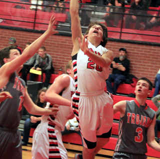 Brandon Anderson drove in from the corner for this lay-up against Troy. Behind him is Jake Bruner.