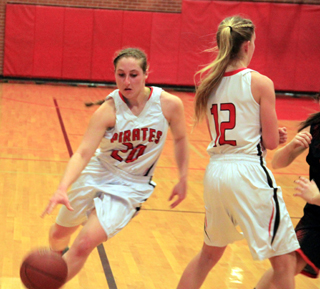 Hailey Danly drives past a pick set by Chaye Uptmor in the girls game against Troy.