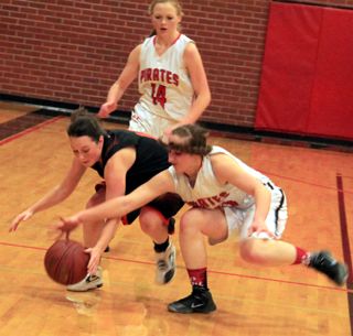Hailey Danly and a Troy player go after a loose ball as Leah Higgins looks on. It wound up as a jump ball.