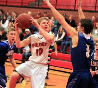 Brandon Higgins drives into the lane against Genesee, drawing the defender. He wound up passing around number 3 to a wide open teammate for a lay-up.