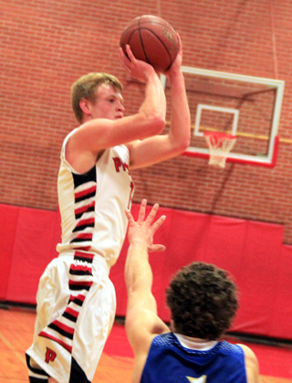 Jake Bruner goes high for a jump shot against Genesee. He scored  a total of 85 points in 4 games this past week for the Pirates, an average of 21.25 per game.