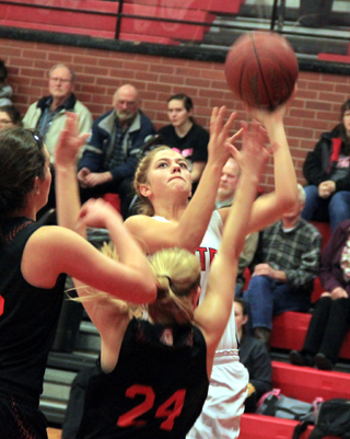 Kylie Tidwell has a determined look as she goes for a lay-up against Troy.