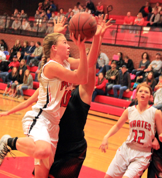 Talyss Lustig goes for 2 of her 10 points against Troy as Josie Peery looks on.