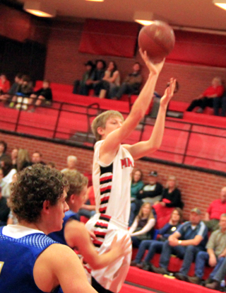Tyson Schlader puts up a jump shot against Genesee. He has been providing quality minutes off the bench for the Pirates this season.