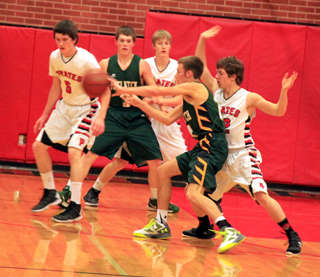 Hunter Chaffee, Tyson Schlader and Thomas Schwartz play defense against Potlatch.