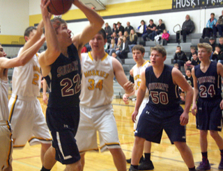 Pat Chmelik looks for a shot at Highland as Chris Osborne and Caleb Currier look on.