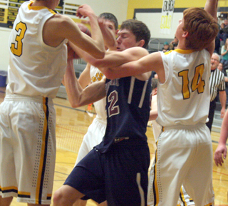Summits Pat Chmelik wrestles for a rebound with 3 Highland players. Photo by Steve Wherry.