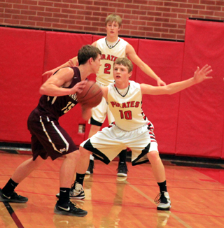 Brandon Higgins defends against a Kamiah player. Tyson Schlader is in the background.