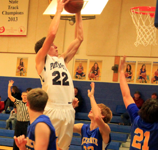 Summits Patrick Chmelik gets up above the rim as he grabs an offensive rebound at Nezperce.