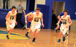 Patrick Chmelik heads upcourt after a steal, flanked by Tyler Krogh, left, and Dylan Krogh, right.