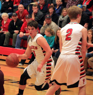 Terran Peery drives past a pick set by Tyson Schlader.