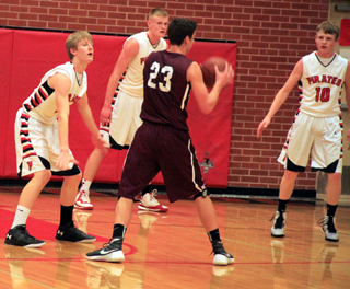 Tyson Schlader, Jake Bruner and Brandon Higgins play defense against Kamiah.