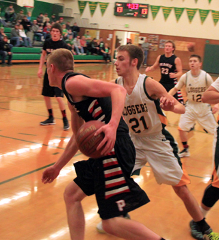 Jake Bruner takes the ball toward the key. He wound up passing it to Hunter Chaffee, left, for a wide open shot just inside the foul line. Also shown is Calvin Hinkelman.