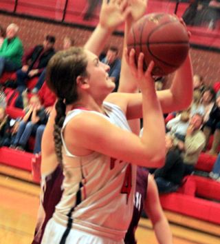 A determined looking Shayla VonBargen puts the ball up from the low block on Senior Night.