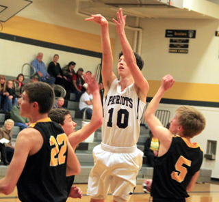 Tyler Krogh puts up a shot for 2 of his 21 points at Highland.
