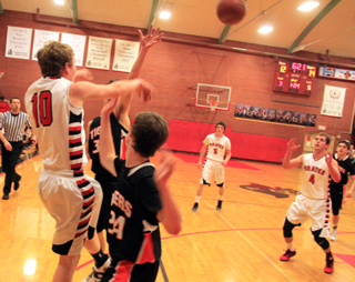 Brandon Higgins passes out of a double team to Isaiah Shears in the Kendrick game. In the background is Hunter Chaffee.