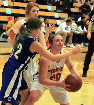 Hailey Danly is about to get fouled as she goes for a basket in the lane. Prairie didnt sink a single basket in the second quarter but took the lead at halftime by hitting 12 free throws. Also shown is Josie Peery.