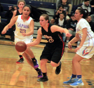 Hailey Danly goes between two Lapwai defenders. Also shown is Chaye Uptmor.