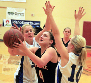 Shayla VonBargen splits a couple of Valley defenders for a lay-up. Also shown is Kylie Tidwell.