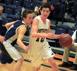 Tyler Krogh drives toward the hoop in the Logos game. Logos threw a box and 1 at the Patriots which held Tyler below his scoring average but opened things up for other players.