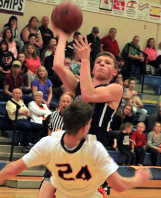 A Kendrick player unsuccessfully tried to draw a charge on Jake Stubbers on this shot at the state tournament.