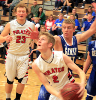 Tyson Schlader goes for a reverse lay-up against Genesee. #23 is Calvin Hinkelman.