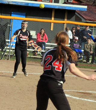 Third baseman Hanna Ross throws to Sarah Seubert at first for an out in the Orofino game.
