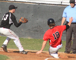 Calvin Hinkelman slides into home with the first run in the Soda Springs game after a wild pitch.