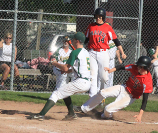 Daniel Mager scores from third on a wild pitch in the second Potlatch game. In the back is Bobby Hood who was at bat.