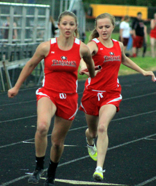 Jordyn Higgins hands off the baton with the lead to Mykaela McWilliams in the 4x200 relay. McWilliams extended the lead by the finish line as Prairie won the event.