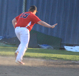 Dereck Arnzen waves off the pitcher as he makes the play at first himself during the second Genesee game.