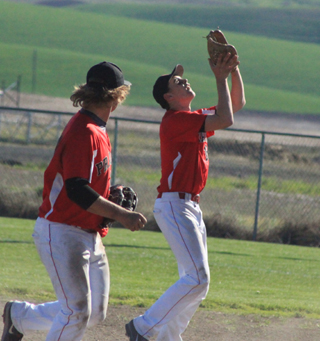 Second baseman Jace Perrin catches a popup in the first Genesee game. Also shown is shortstop Calvin Hinkelman.