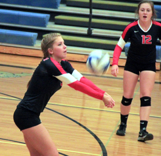 Chaye Uptmor makes a pass at Genesee as Angela Wemhoff watches.