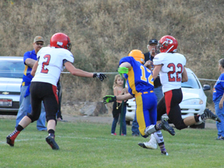 Brandon Anderson races down the sideline after catching a pass for the games first touchdown. Jake Stubbers, 2, is about to block the last player with any chance at tackling Anderson.