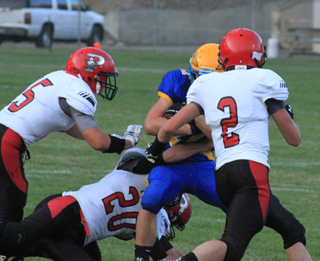 Caleb McWilliams, Hunter Chaffee and Jake Stubbers meet at the ballcarrier.