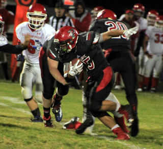 Caleb McWilliams carries the ball as Hunter Chaffee and another Prairie player block for him.