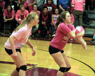 Angela Wemhoff makes a pass at Kamiah as her cousin Leah Higgins watches.