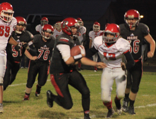Spencer Schumacher carries the ball against C.V. Other players from left are Jace Perrin, Dereck Arnzen and Carson Schmidt.