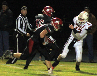 Brandon Anderson is about to get a key block from Carson Schmidt, 56, on his way to a touchdown.