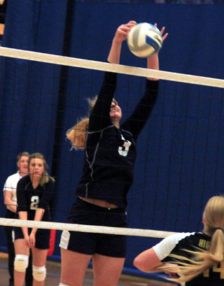 Summits Ally Sonnen makes a block against Highland at District. In the back is Kayla Rehder.