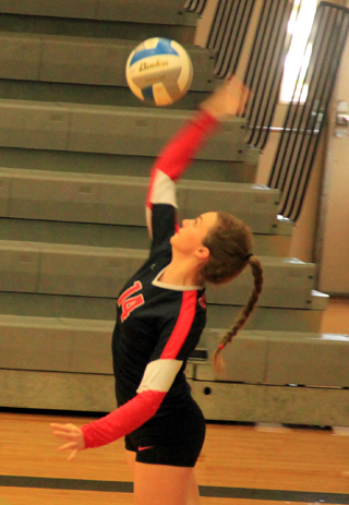 Kristyna Krogh serves against Idaho City.