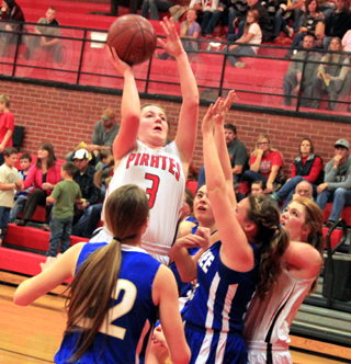 Angela Wemhoff puts up a shot against Genesee. At right is Josie Peery.