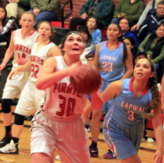 Sydney Bruner got inside for a rare open look against Lapwai. Also shown are Leah Higgins and India Peery.